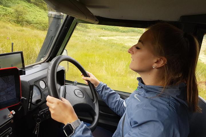 Lady driving Land Rover Defender